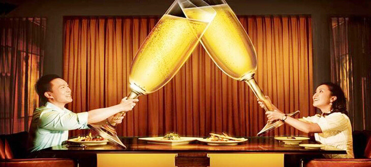 couple holding giant champagne glass at Prego, The Westin KL
