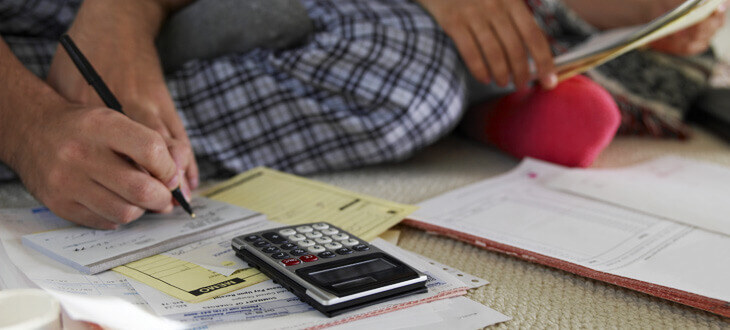 couples sitting together calculating bills and expenses
