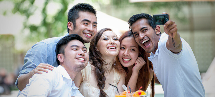 A group of asian friends taking selfies